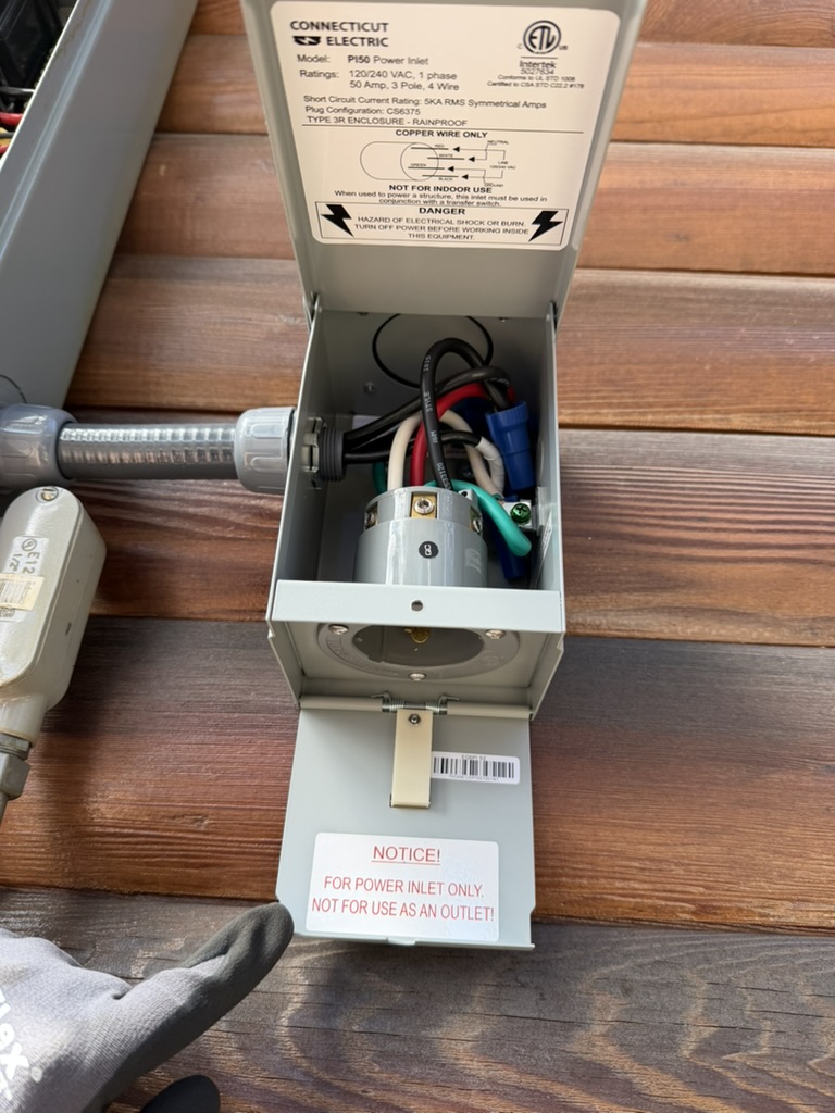Open 50-amp generator inlet showing its wiring connections