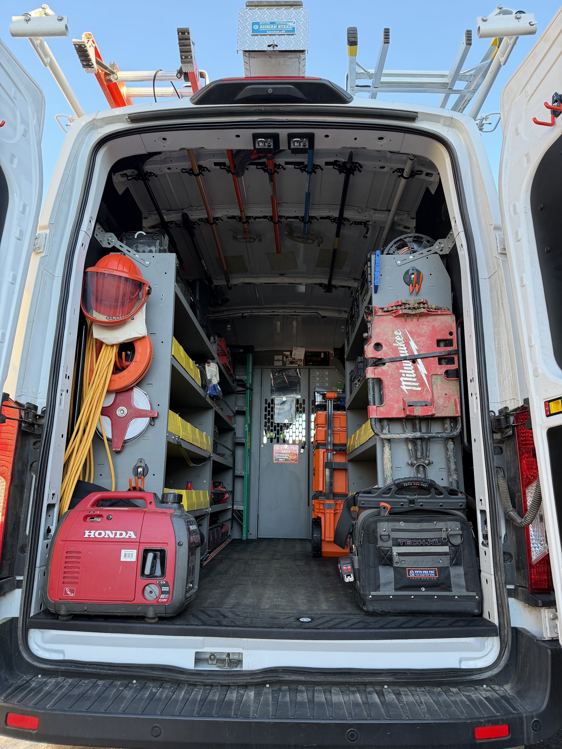 Open service van with organized electrical tools and equipment