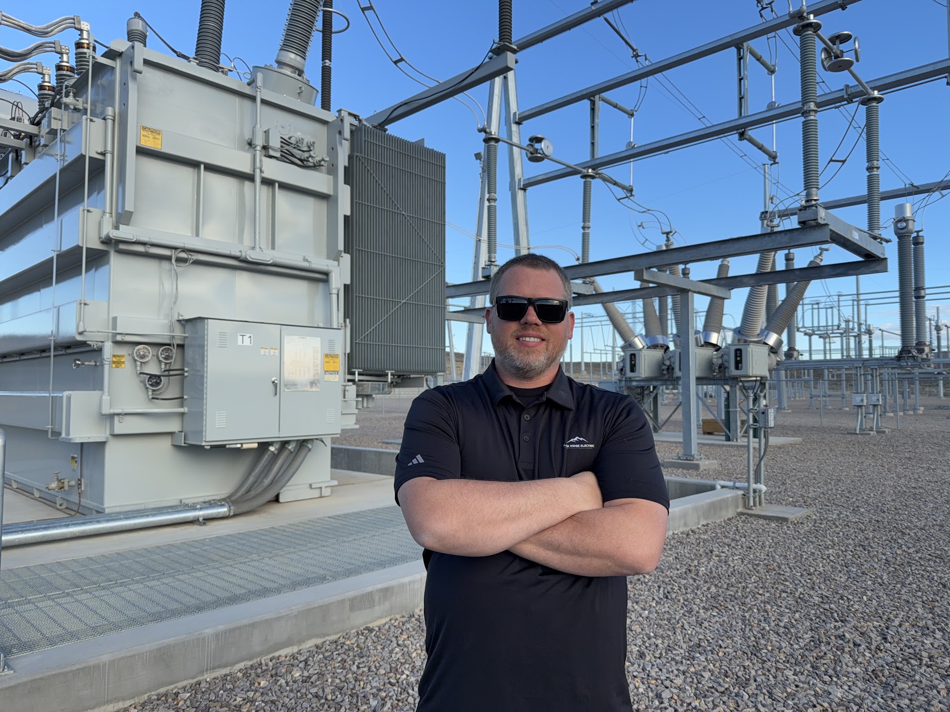 Owner Gil Villegas wearing a Black Ridge Electric polo at an electrical substation