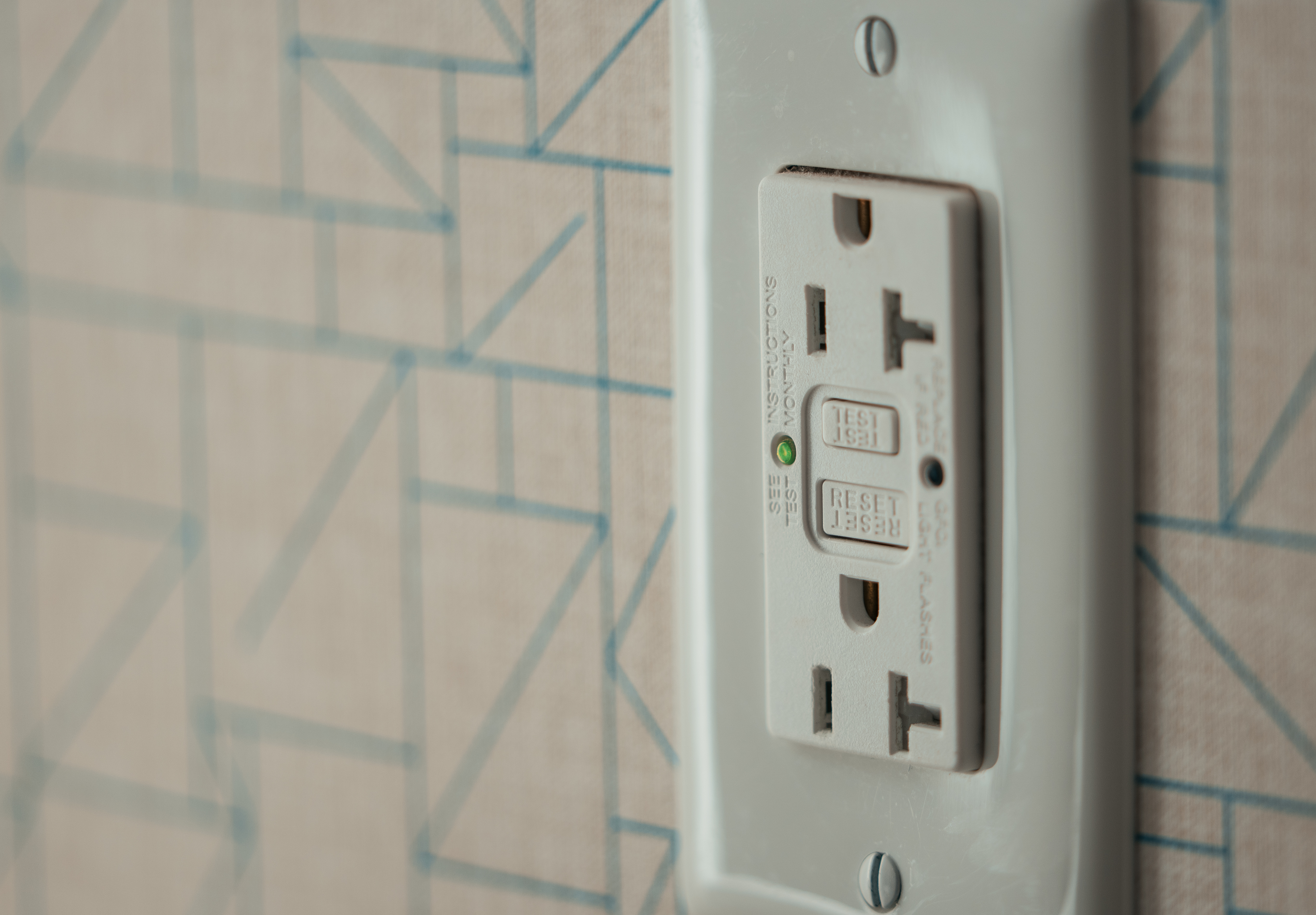 Indoor U.S. GFCI outlet with TEST and RESET buttons and a green indicator light.